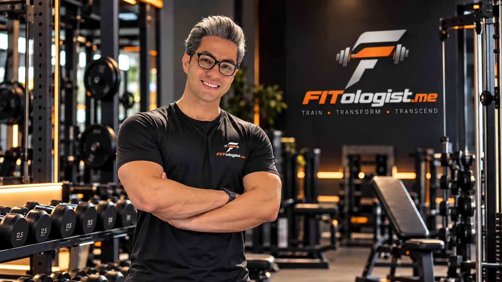 Saeid, personal trainer, smiling with arms crossed in a Dubai gym